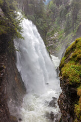 Obraz premium The largest of the three riva di tures waterfalls.The three Riva waterfalls are located in Valle Aurina, at the entrance to the Vedrette di Ries-Aurina Natural Park.