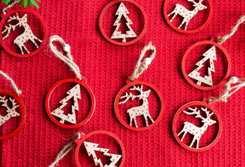 Christmas wooden decorations on red background, top view