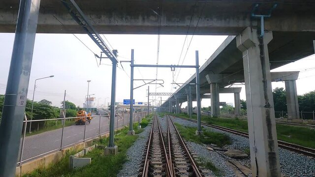 BANGKOK, THAILAND - NOVEMBER 10, 2021: Point of view shot The new electric train named &ldquo;SRTET Red Line&rdquo; running on railway.