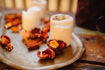 white candles and dried flowers on a tray as a retro style decor 