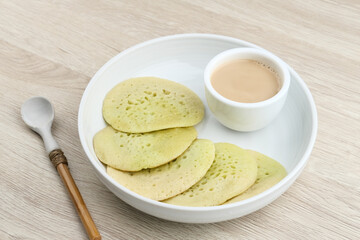 Serabi or Surabi,  Indonesian pancake made of flour, rice flour and coconut milk. Served with palm sugar sauce. Sweet and savory. Selective focus image.

