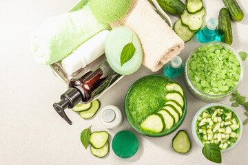 Obraz na płótnie Canvas Homemade cosmetics with cucumber. Natural cream, sea salt, body lotion, and soap