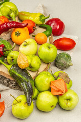 Fototapeta na wymiar Trendy ugly organic vegetables and fruits on stone concrete background