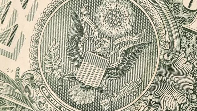 Great seal on 1 US dollar bill slow rotating, bald eagle.