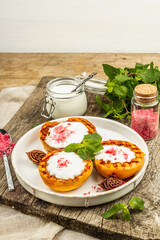 Grilled peach with yogurt, mint, and sweet pink sugar. Useful breakfast concept, healthy food