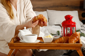 Breakfast in a bright bed on a beautiful Christmas morning, hot coffee and fresh chruasants 