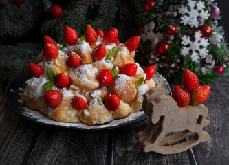 Delicious Christmas cake made of profiteroles with strawberries. Christmas Holiday Recipes - 469666775