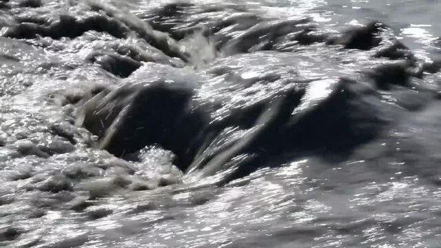 river of mud and water rushes towards the sea after intersting rains