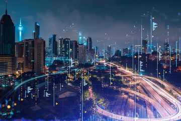 Fototapeta na wymiar Stock market graph hologram, night panorama city view of Kuala Lumpur. KL is popular location to gain financial education in Malaysia, Asia. The concept of international research. Double exposure.