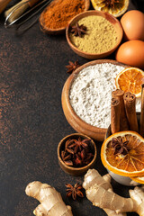 Ingredients for gingerbread cookies on the dark culinary background. Assortment of food for Christmas or New Year's holiday baking