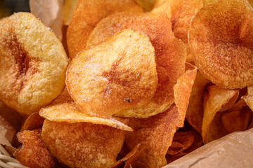 Closeup on fried potato chips appetizer snack texture