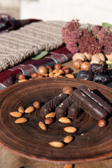 Chocolate with caramel and nuts. Copy space. Close-up. Soft focus background.