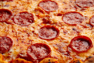 Closeup on pepperoni pizza with salami texture background - obrazy, fototapety, plakaty