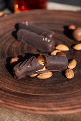 Chocolate with caramel and nuts. Copy space. Close-up. Soft focus background.