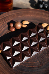 Chocolate with almond on brown dish. Close-up. Copy space. 