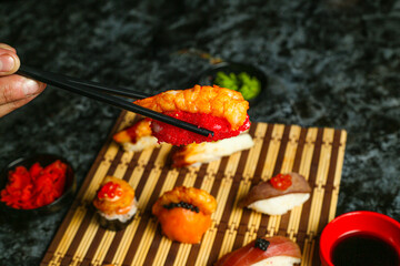 Traditional delicious fresh sushi roll set on a black background