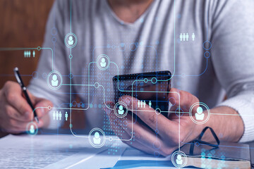 A potential employee signing the contract to boost his career and gain new opportunities in personal growth. Concept of success. Checking the detail of the deal at smartphone. Social media icons