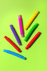 Bright new straight pop tubes on green paper background