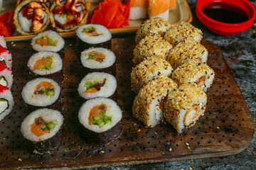 Traditional delicious fresh sushi roll set on a black background