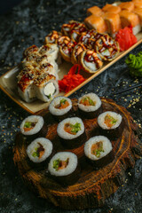 Traditional delicious fresh sushi roll set on a black background