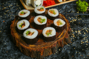 Traditional delicious fresh sushi roll set on a black background