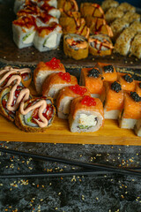 Traditional delicious fresh sushi roll set on a black background