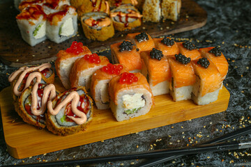 Traditional delicious fresh sushi roll set on a black background