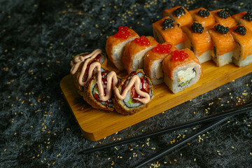 Traditional delicious fresh sushi roll set on a black background