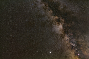 Night sky with many stars, milky way galaxy near Scutum and Aquila constellation, purple nebulas -...