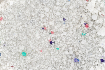 Washing powder under microscope - image width 23mm, colourful granules are optical brighteners