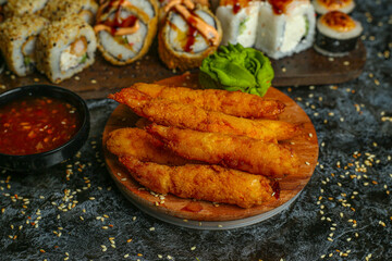 Traditional delicious fresh sushi roll set on a black background