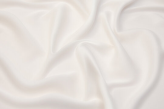Close-up texture of natural beige or ivory fabric or cloth in brown color. Fabric texture of natural cotton or linen textile material. Beige canvas background.