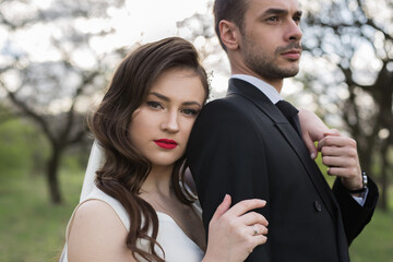 Bride and groom in the green forest