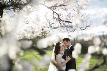 Bride and groom in the green forest