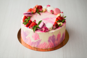 Beautiful cake with strawberries and macaroons