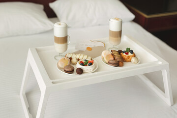 The bride and groom gatherings on the wedding day. Romantic breakfast with fresh pastries and coffee in bed.