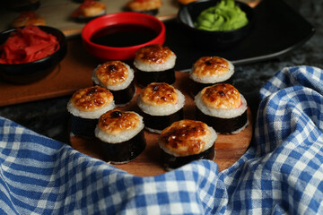 Traditional delicious fresh sushi roll set on a black background