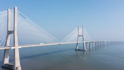 Aerial view of the most beautiful Portuguese bridge in Lisbon, Vasco da Gama. Morning foggy seascape.