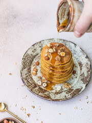 Pumpkin pancakes with hazelnuts and maple syrup