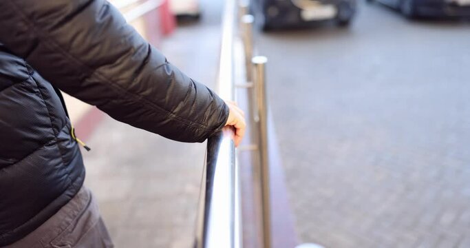 Man comes down holding on to metal railing slow motion 4k movie