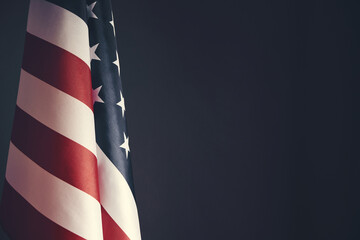 Standing flag United States of America on dark gray background.Banner of America in retro style.