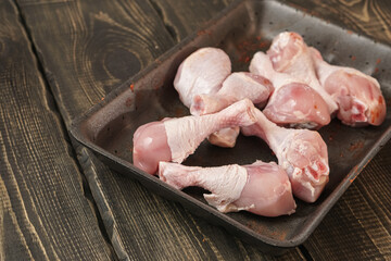 Chicken thighs on a wooden table. Raw chicken meat.