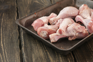 Fototapeta na wymiar Chicken thighs on a wooden table. Raw chicken meat.