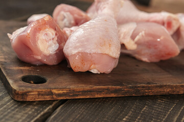 Chicken thighs on a wooden table. Raw chicken meat.