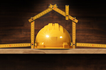 Yellow safety helmet and folding ruler in the shape of house above a wooden shelf. Concept of...