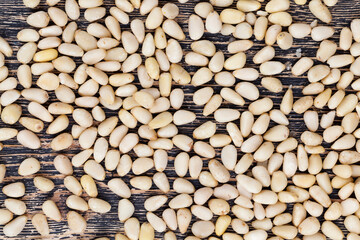 a large number of pine nuts on a wooden table