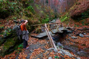 Travel photographer with camera in the mountains