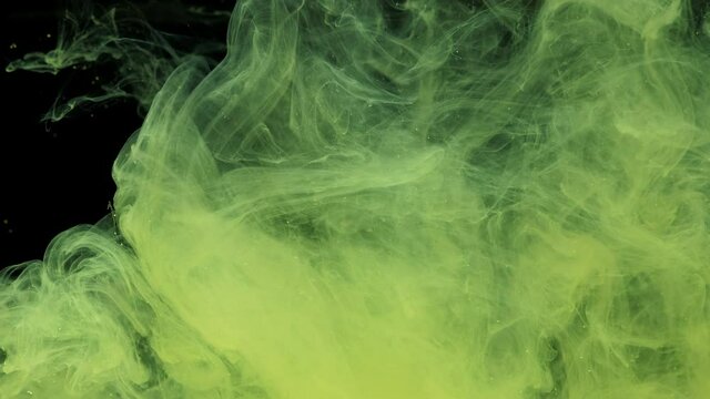 Yellow ink acrylic paint mixing in water, swirling softly underwater. Colored citric acrylic cloud of paint in aquarium. Slow motion abstract smoke explosion animation. Beautiful art background