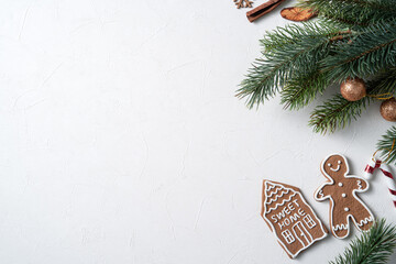 Decorated Christmas gingerbread cookies with decorations on white table background.