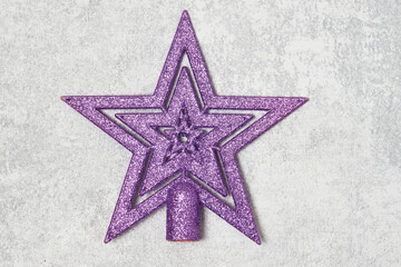 Christmas tree star on gray background, top view